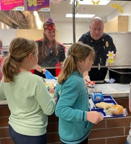 school nutrition and fire department serve lunch to students