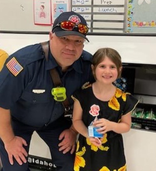 fire fighter with child at school lunch