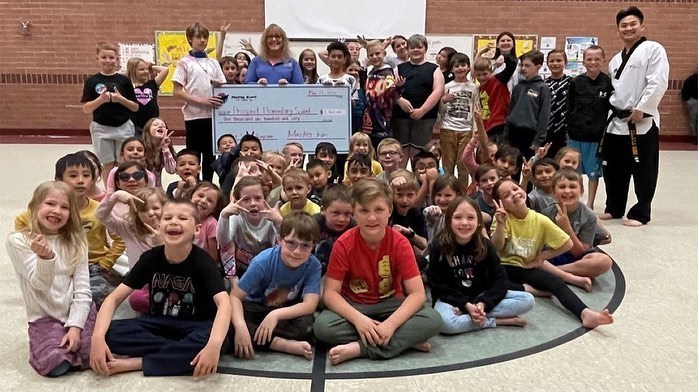 prospect students with large check for PE classes