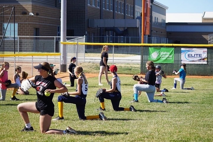 Owyhee softball pitching to young campers
