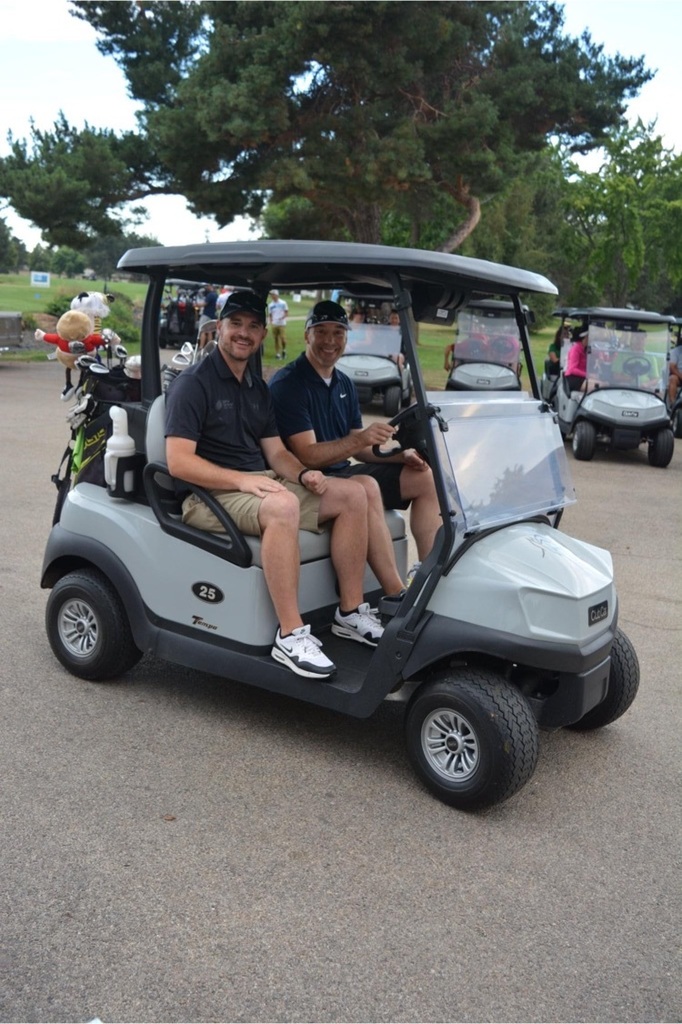 two men in golf cart